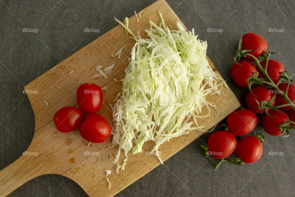 Flat lay - preparing tomatoes and cabbage  salad with onion