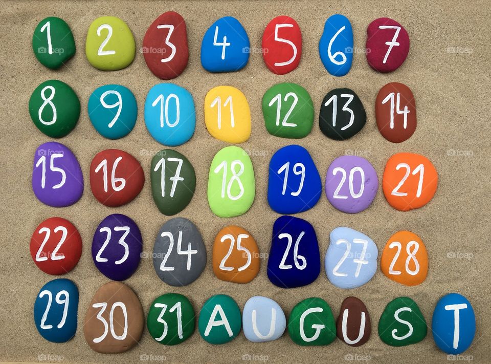 August, calendar on colored stones 