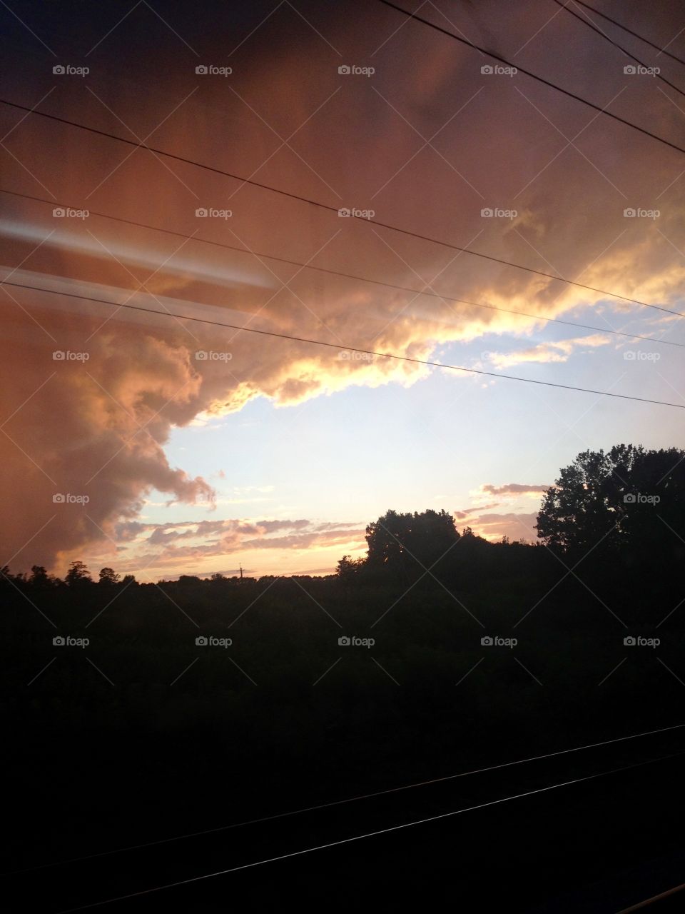 Stormy clouds on a sky in sunset on the rails