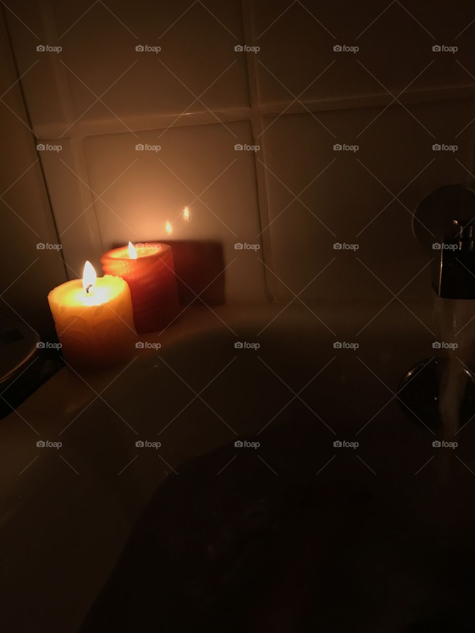 Candles near a bath 