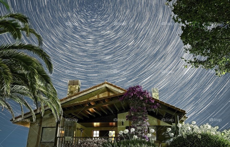 Star trails over a beautiful house 