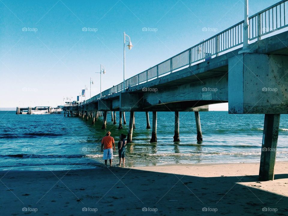 Couple in beach by pier