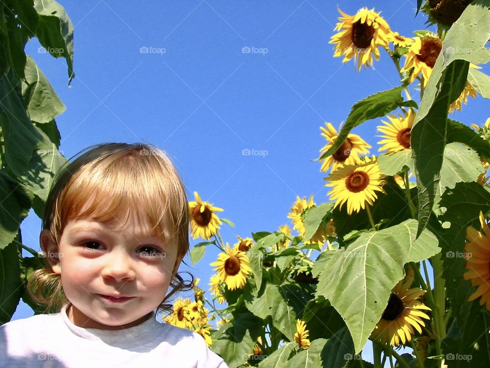 Happy toddler enjoying the garden. 