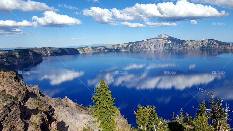 Mountains and clouds reflecting on lake