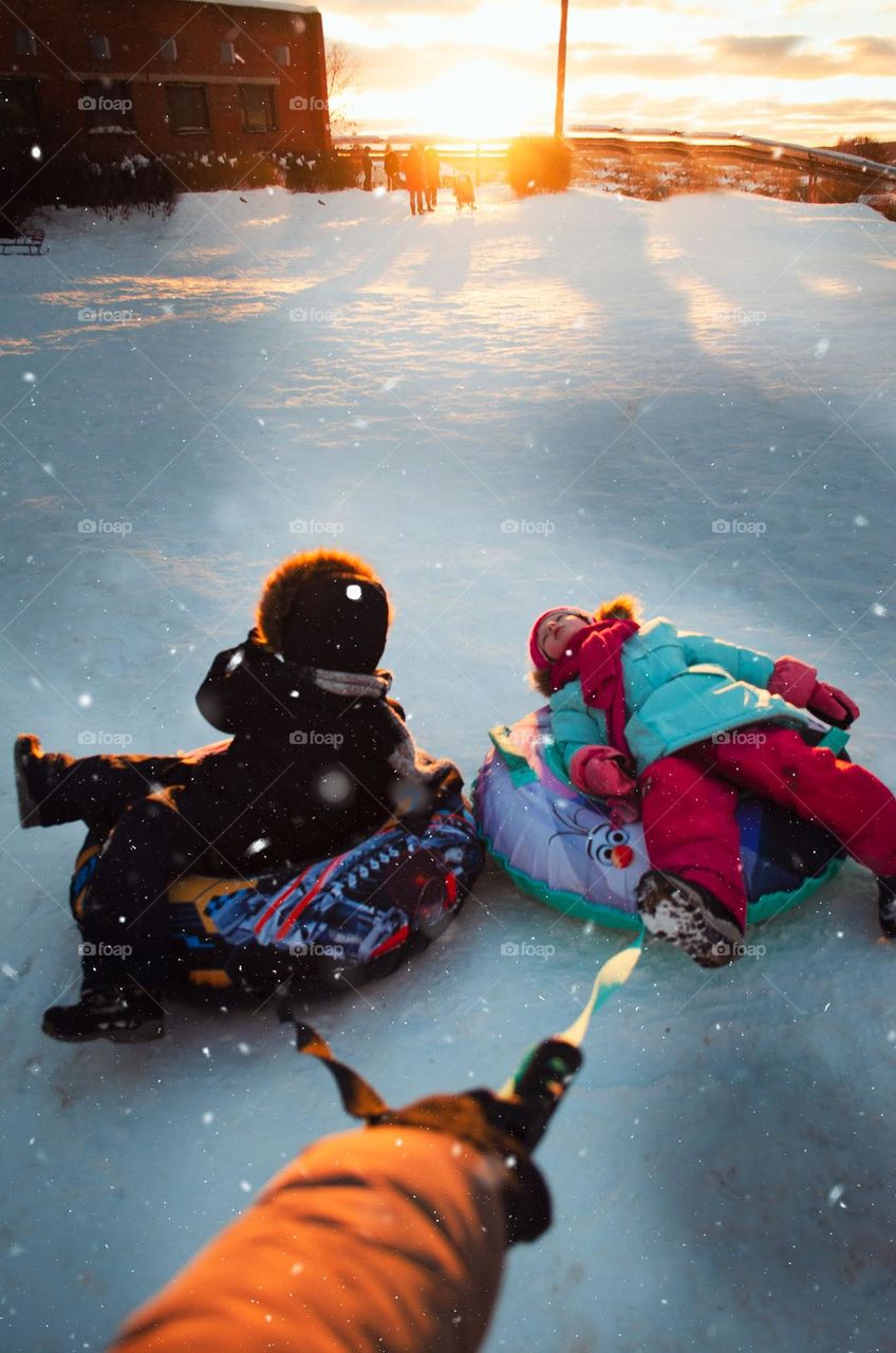 Children ride a slide on the tubing.