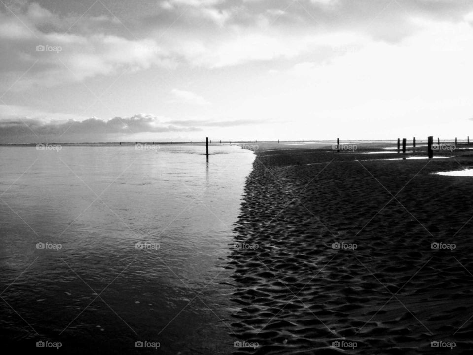 Black and white picture of a beach in Northern Ireland. It is calm and peaceful