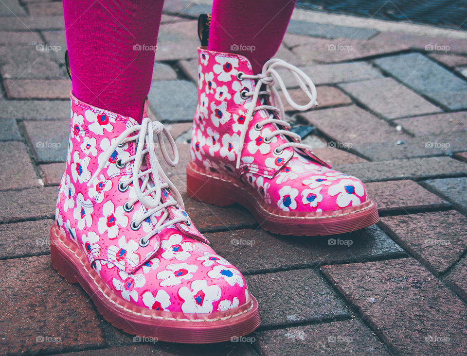 Fabulous pink, floral DMs worn with shocking pink tights, standing on pink and grey cobblestones