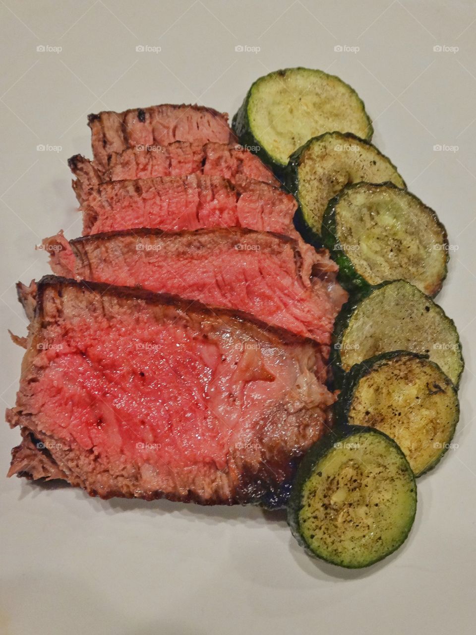 Sliced steak with zucchini
