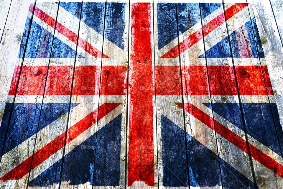 Flag of the United Kingdom of Great Britain on a wooden background