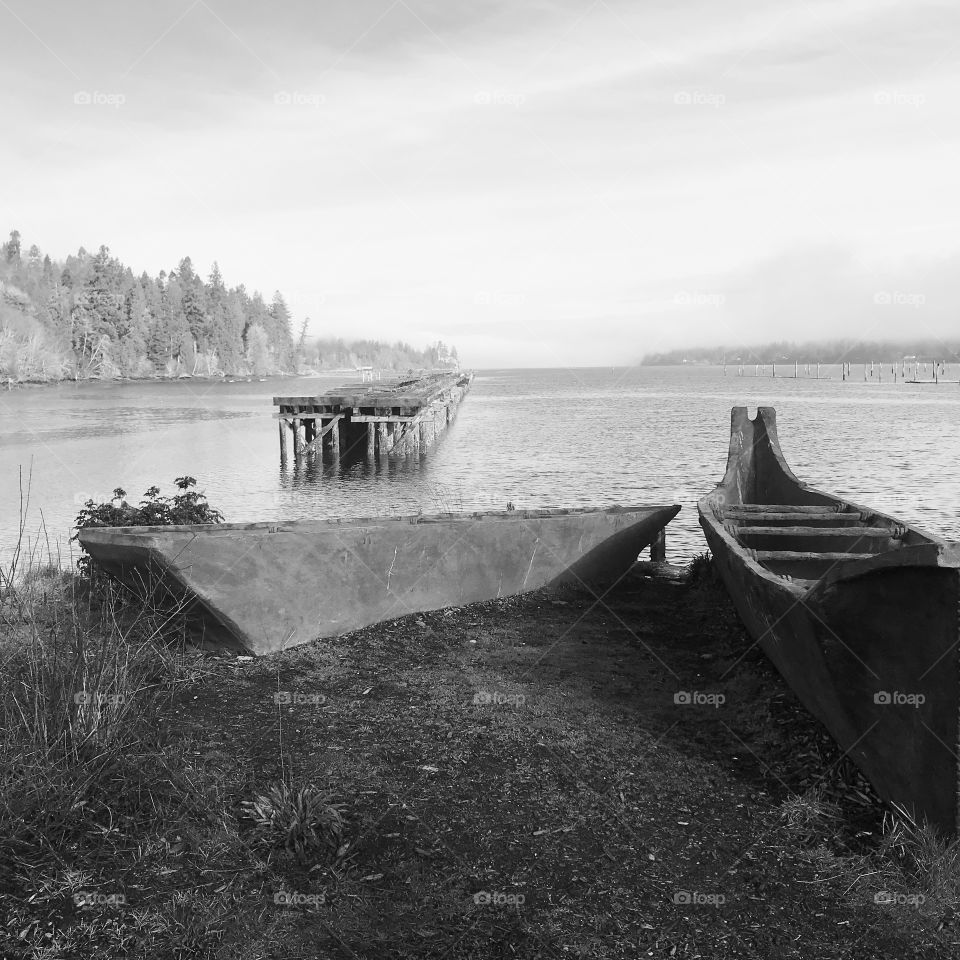 Old logging pier with railroad tracks and some canoe sculptures as a reminder of who originally lived and worked the land.