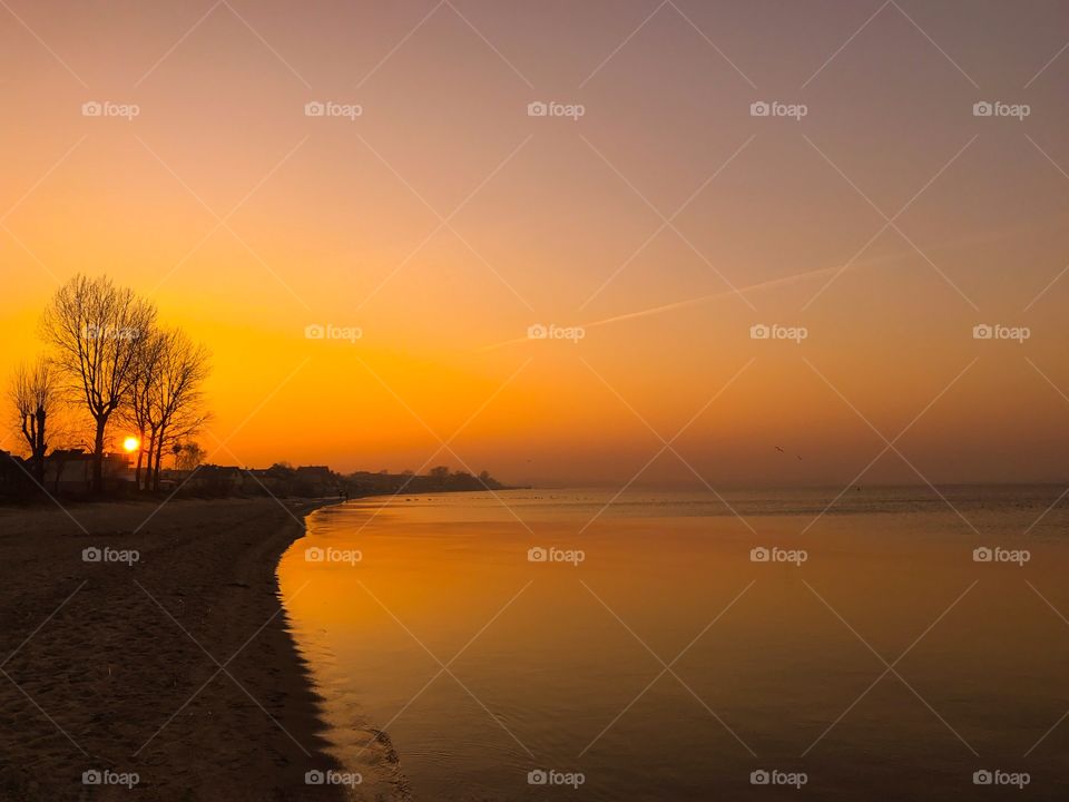 Sunset and dramatic sky at lake