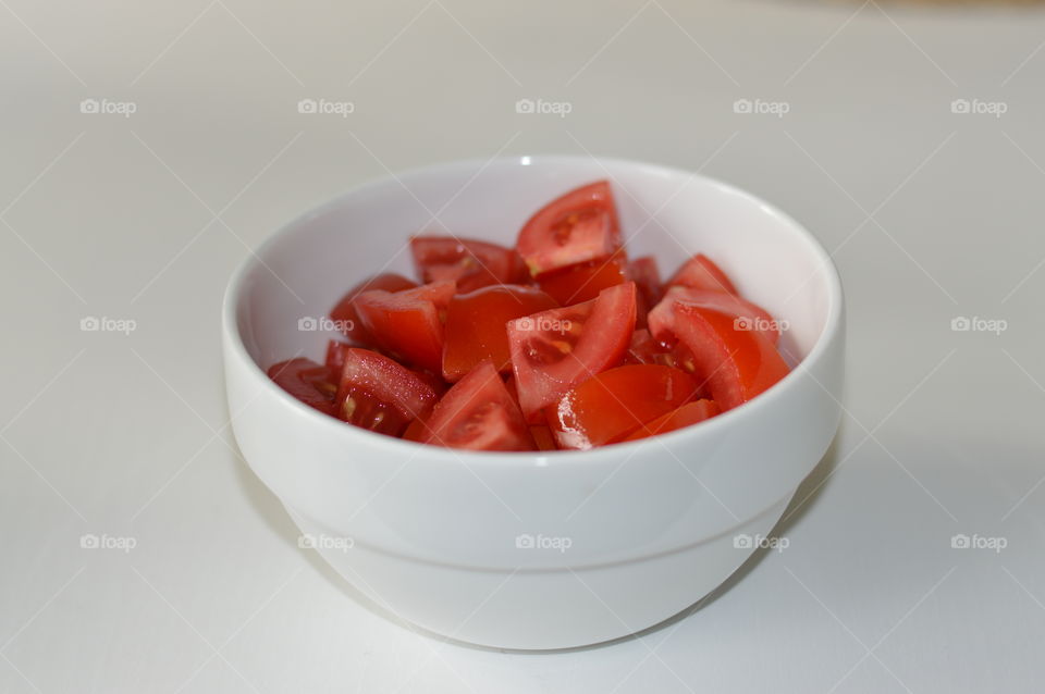 A bowl with pieces of tomatoes.