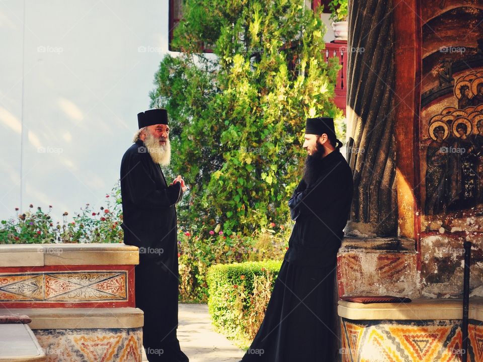 Quiet Noise. Two monks enjoying the moment in front of the oldest Christian Church from Romania...