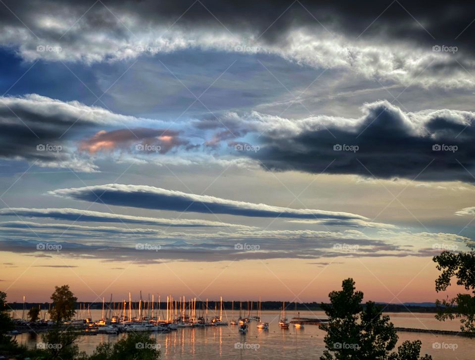 Sailboats in a safe harbor at sunset 