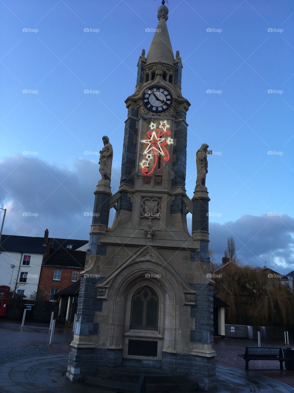 Illuminated clock tower, enhanced by a small Xmas decoration.