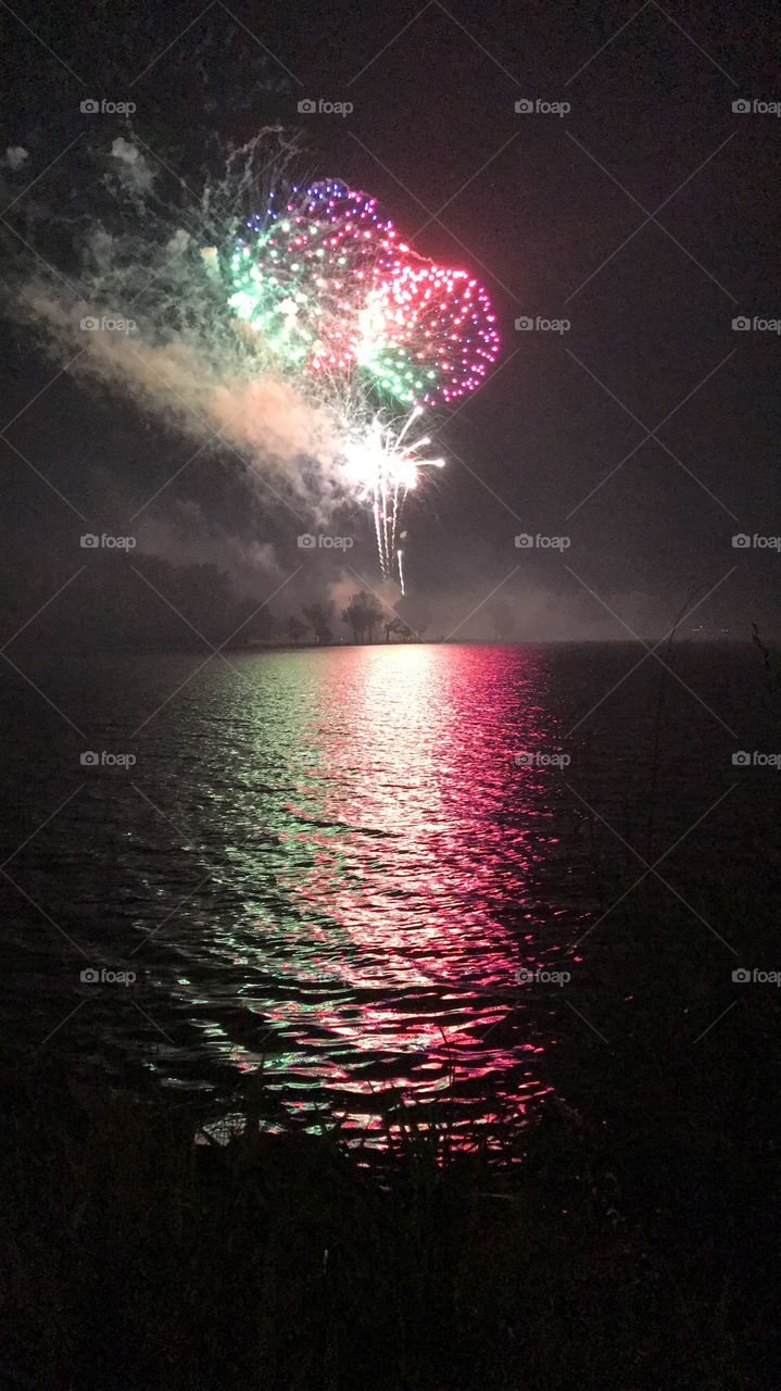 Bright, colorful fireworks over a lake in Council Bluffs, Iowa