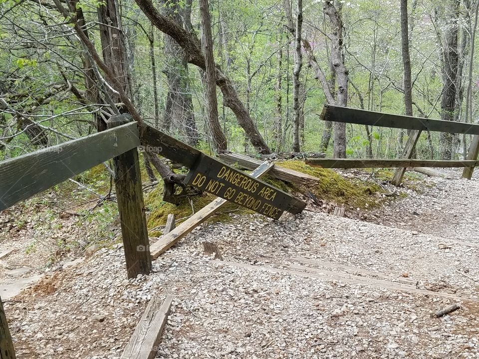 broken danger sign on hike
