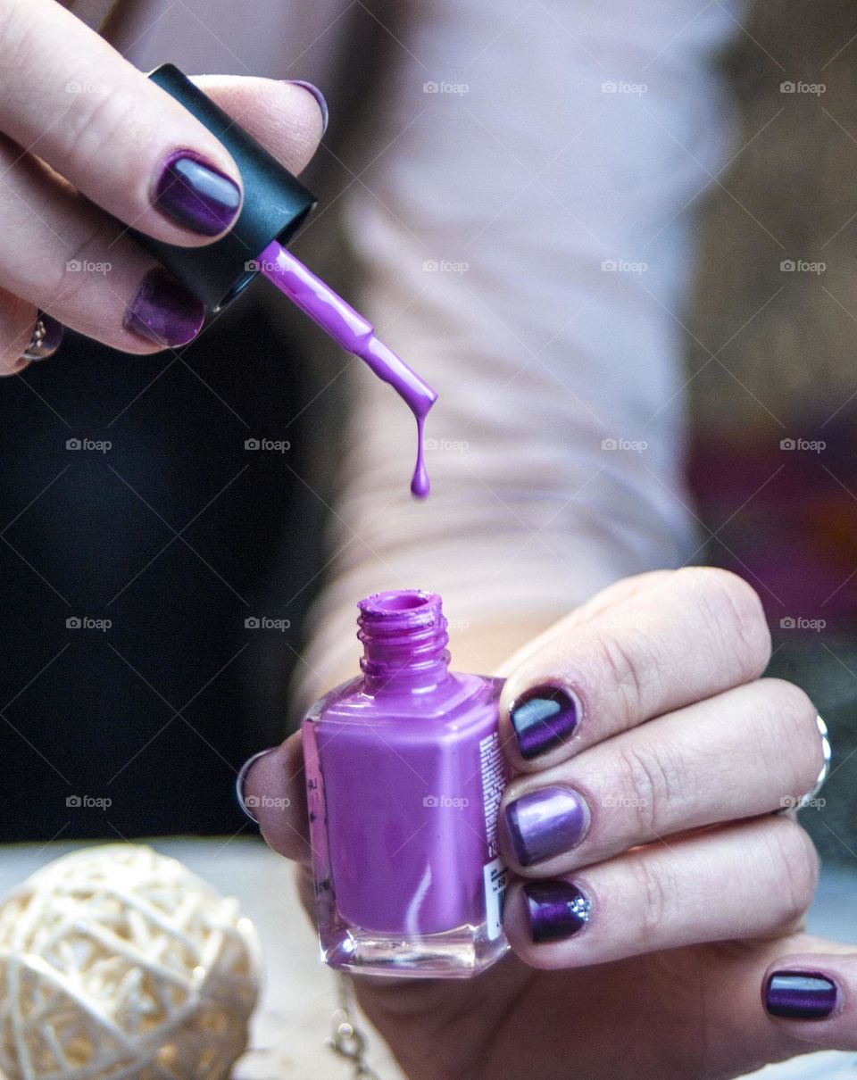 woman paints her nails with varnish