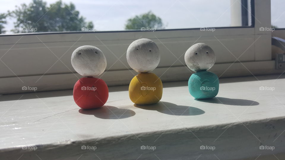 3 clay figures relaxing in the sun