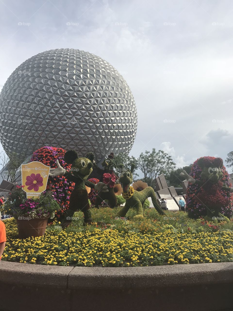 Mickey, Minnie, and Pluto with the Epcot ball in the background. 