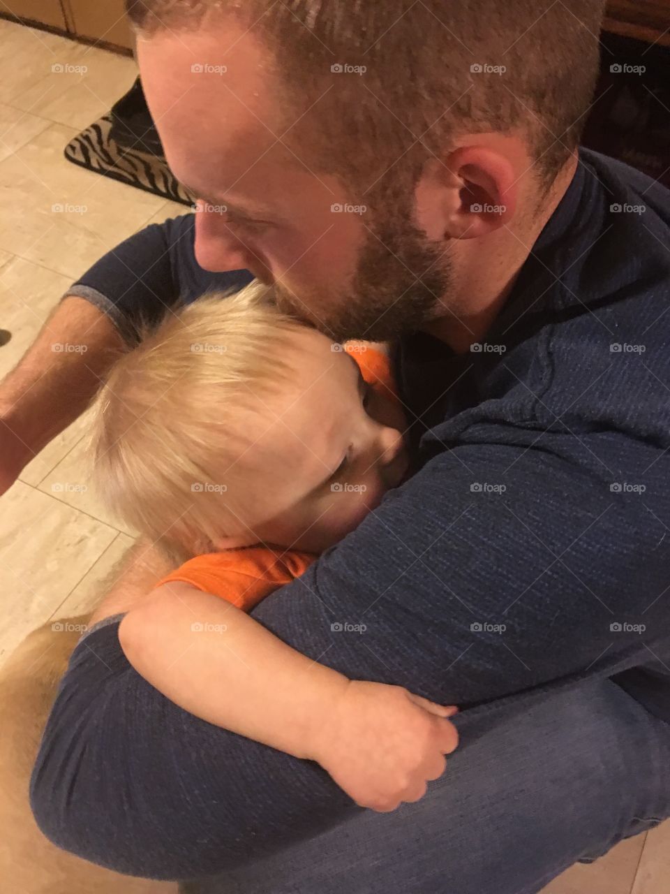 That baby sure loves his daddy