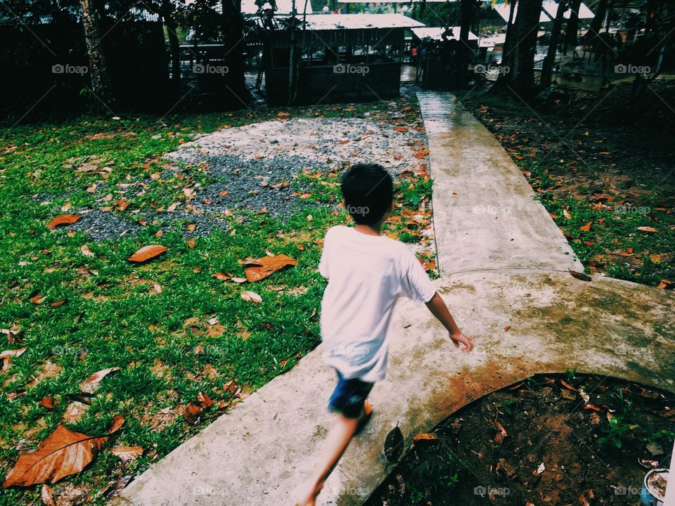 A boy walking in a park