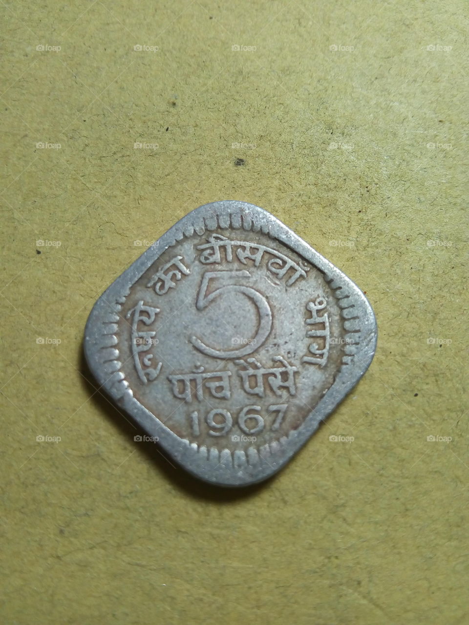 A coin of five paise- 1/20 share of Indian Rupee issued by Government of India in 1967.