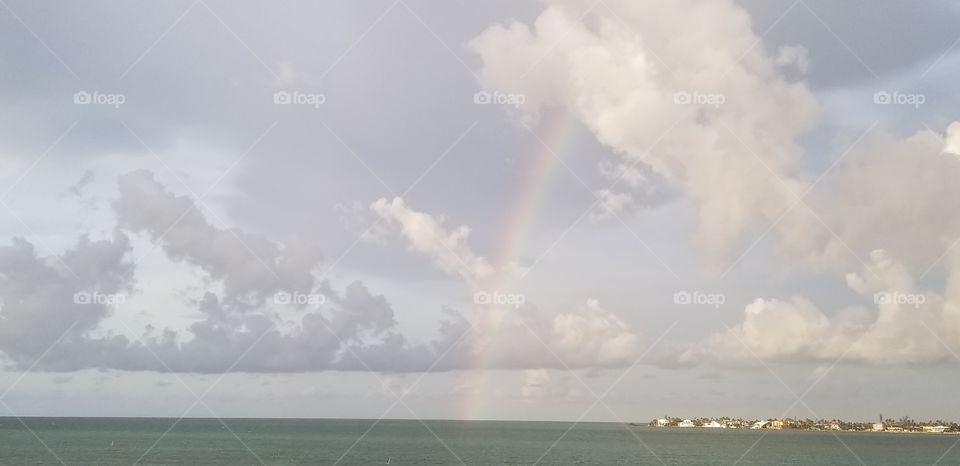 rainbow into ocean