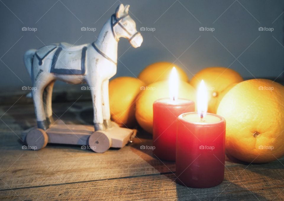 Candle red color flame close-up orange toy Winter celebration christmas decoration wood table textured background blur