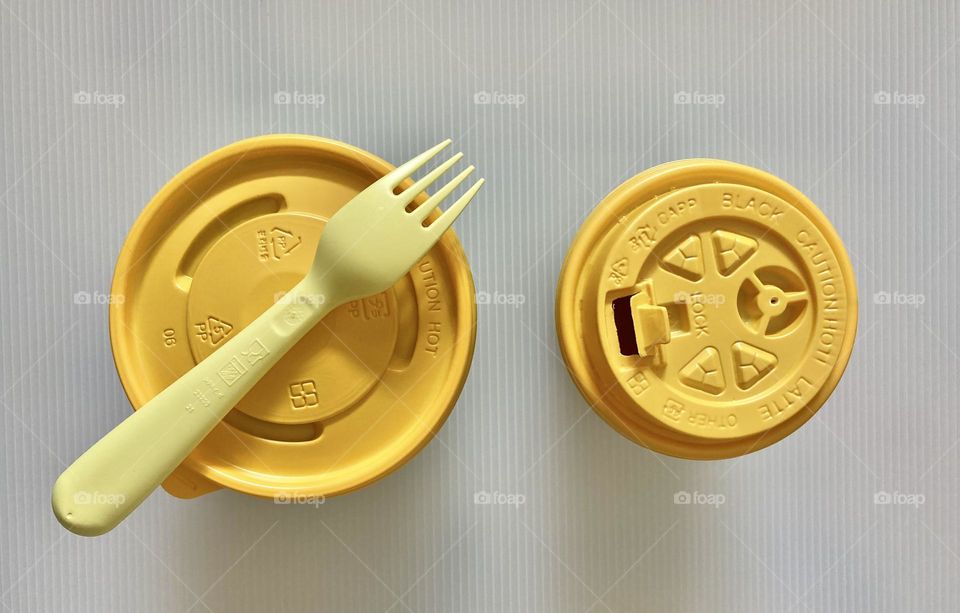 Top view of takeout food and drink in yellow containers 