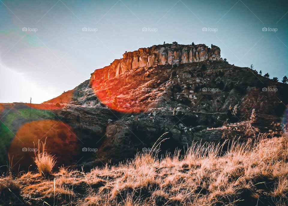 Red lens flare over the beautiful mountain.