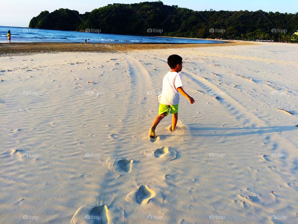 Running boy on the beach