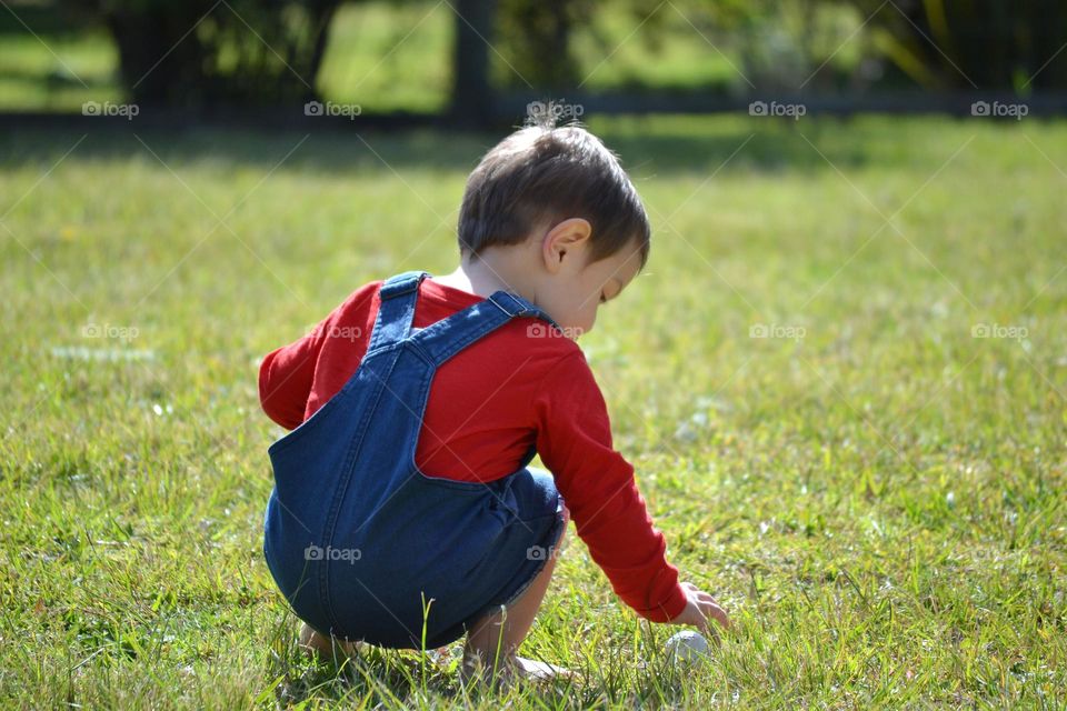 Cute little toddler boy playing outside