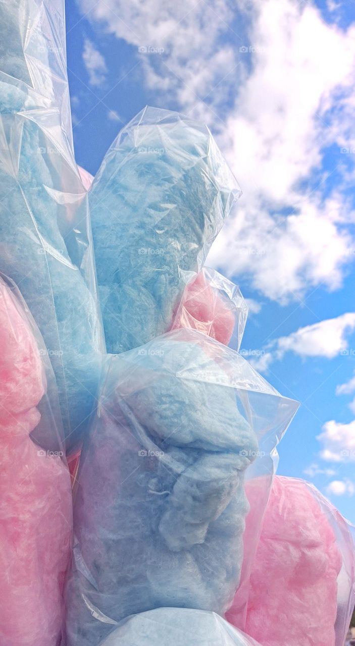 Pink and blue cotton candy and blue sky and clouds