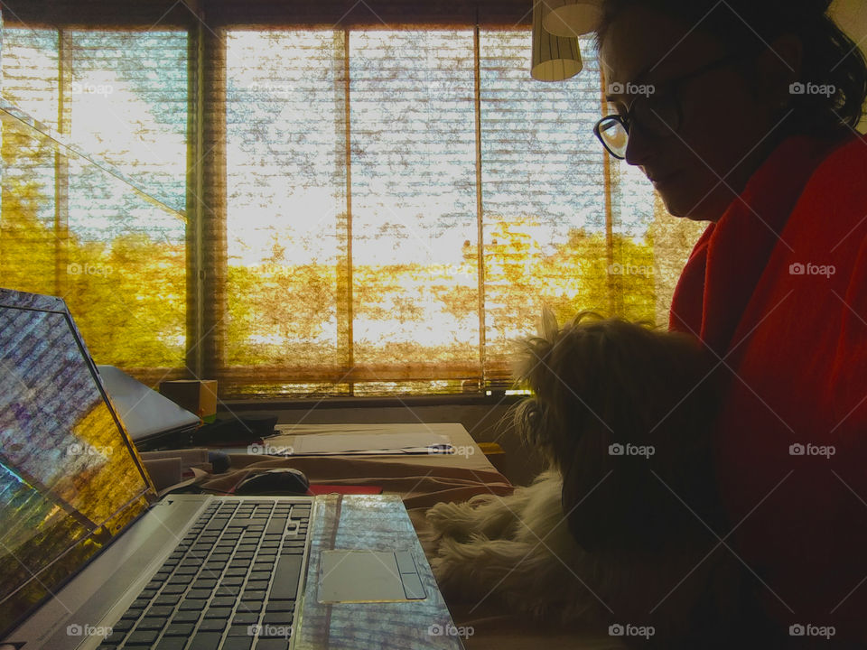 Girl working from home with her dog