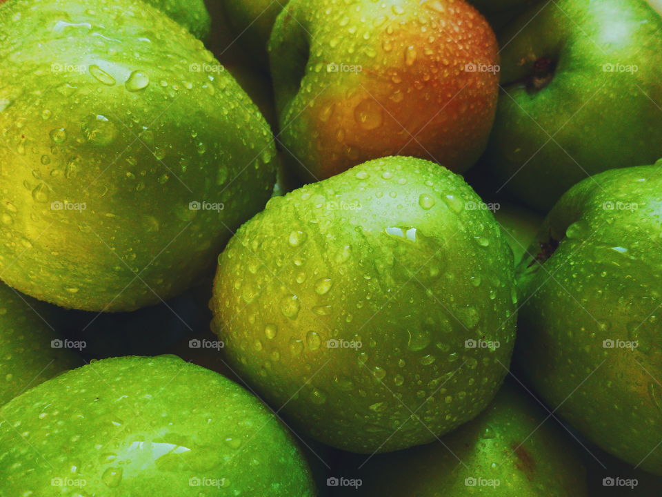 drops of water on green apple varieties of simirenko