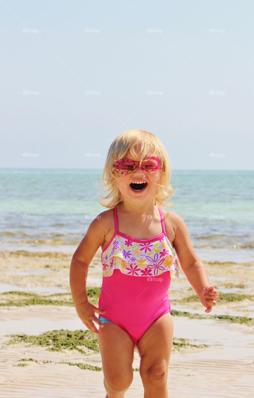 Little girl at play at the beach