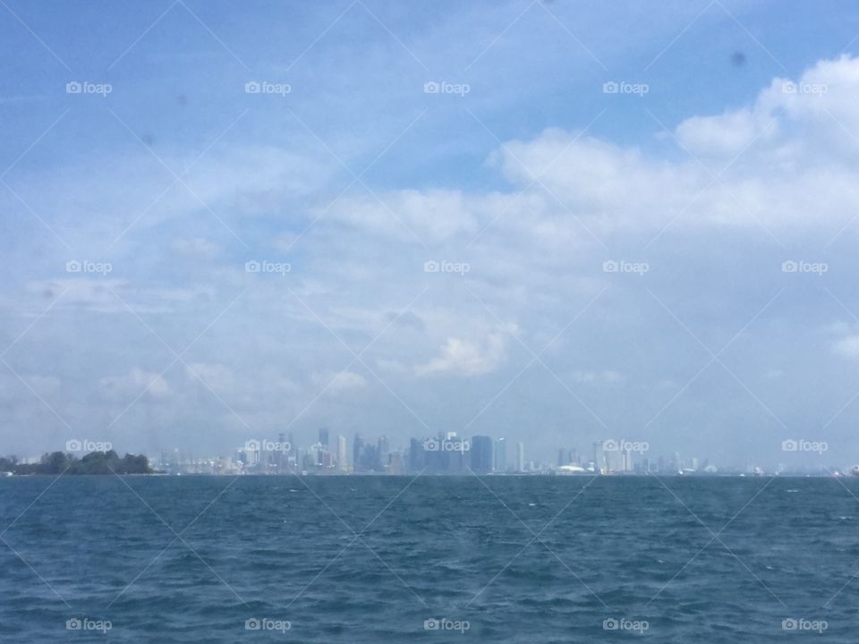 Singapore seen from see. City skyline with a lot of high rise buildings.