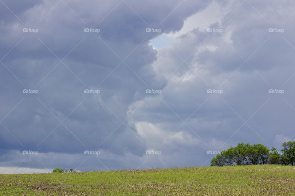 Steel blue storm clouds on a prairie horizon