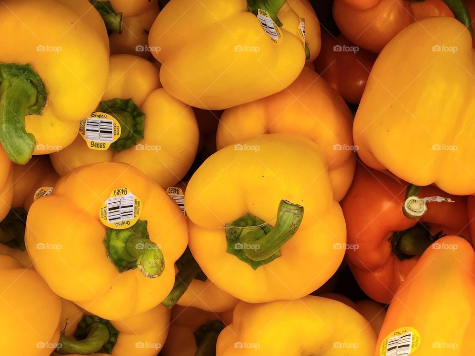 close up view of fresh yellow bell peppers for sale in an Oregon market ready for snacks and delicious meals