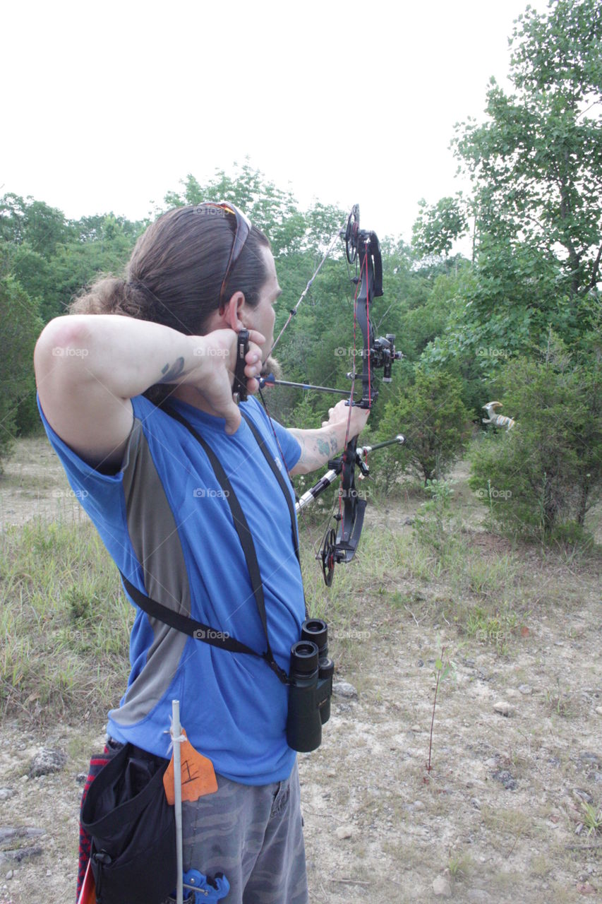 Archery tournent. Archery tournament shooting in a novelty shoot at a dinosaur 