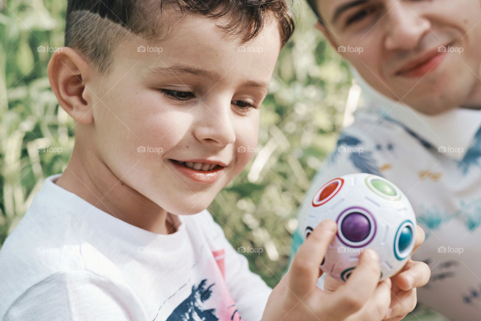 Cute boy playing with dad