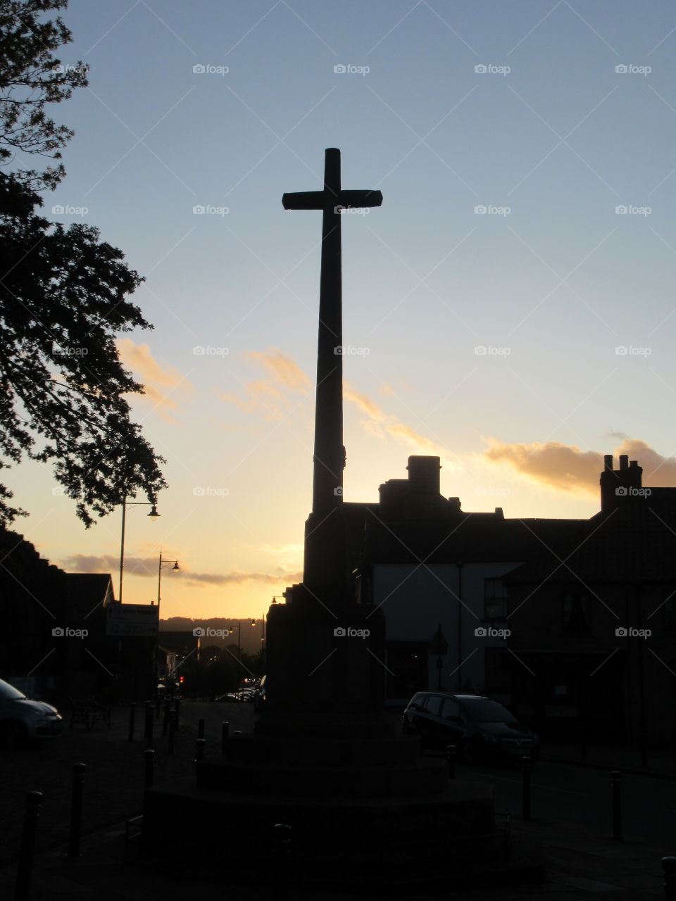 Cross standing tall against the rooftops