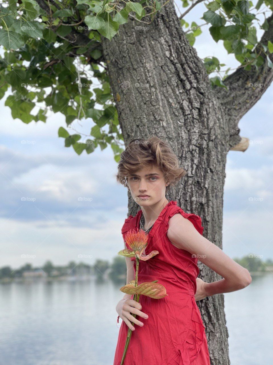 Non binary boy girl in red dress