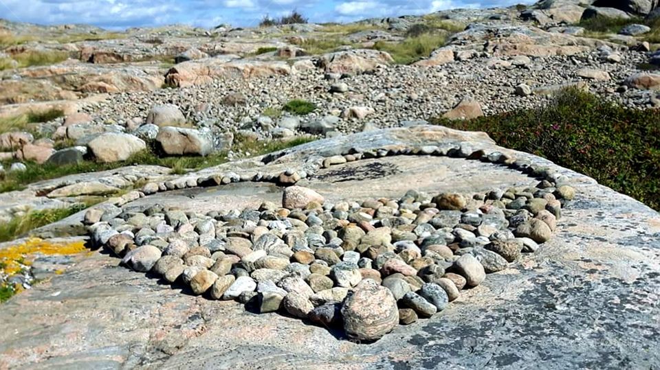 Artwork of stones as a heart on the cliffs