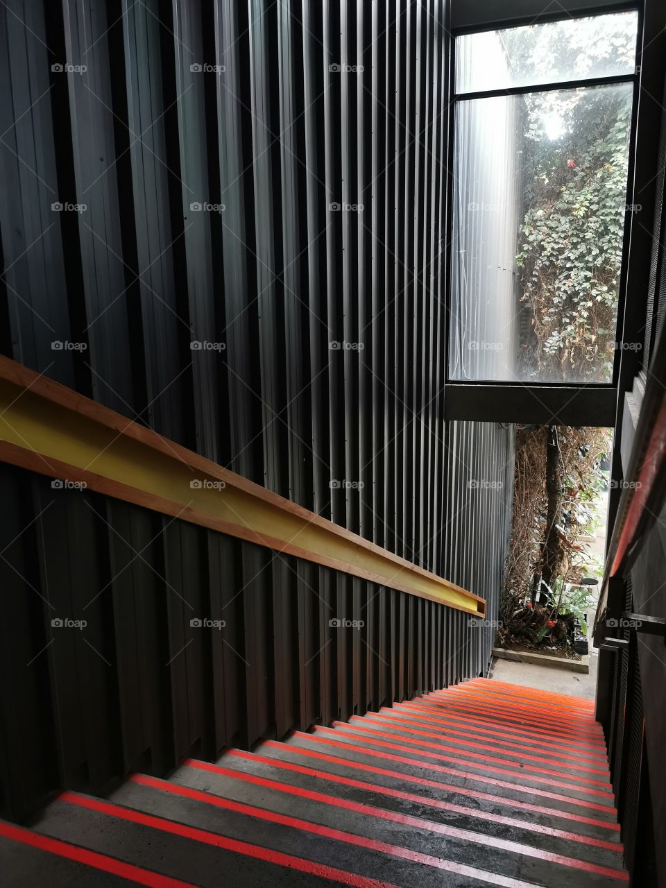 Orange stripe stair with black wall