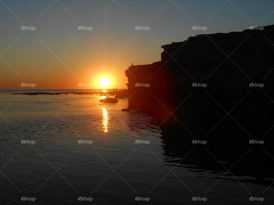 sunset on a sea shore and people summer time