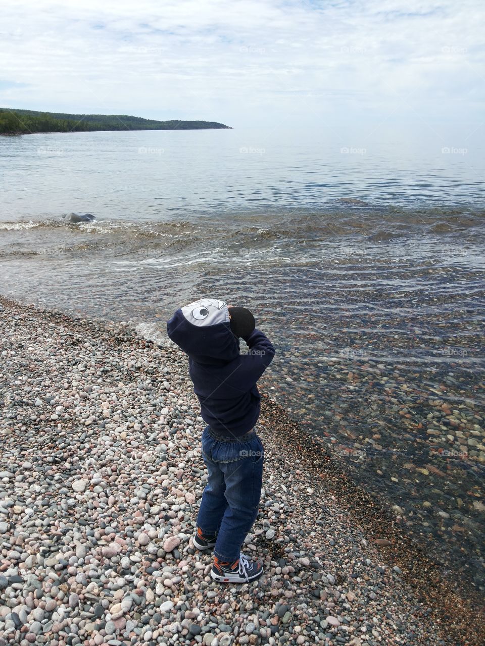 Child standing by the water