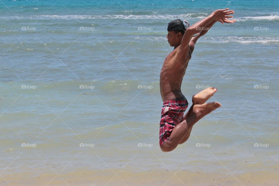 Boy Jumping At The Beach