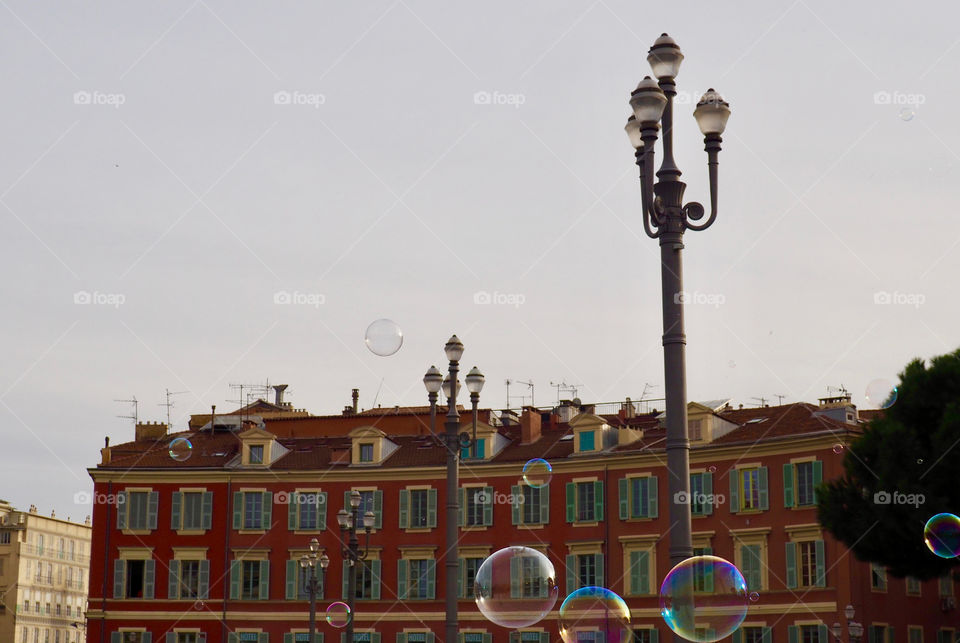 Bubbles in foreground of view of Place Massena in Nice, France.